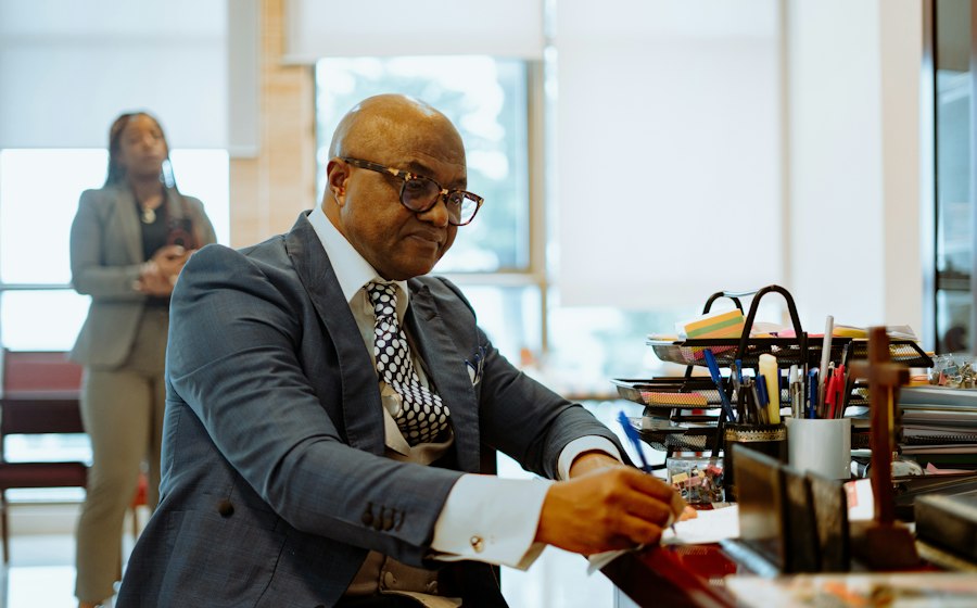 An advisor reviewing documents at his desk